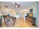 Bright living room with hardwood floors, leather furniture, and large TV at 4532 Shark Dr, Bradenton, FL 34208