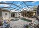 Inviting pool area with covered patio, lush landscaping, and comfortable seating at 4532 Shark Dr, Bradenton, FL 34208