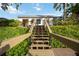 Wooden stairs leading down to a waterfront deck at 4532 Shark Dr, Bradenton, FL 34208