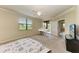 Bedroom featuring neutral tones, a ceiling fan, and a sliding glass door providing natural light at 6708 Grand Estuary Trl # 104, Bradenton, FL 34212