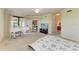 Bedroom showcasing a grand piano, neutral tones, ceiling fan, and doorway leading to additional rooms at 6708 Grand Estuary Trl # 104, Bradenton, FL 34212