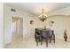 Cozy dining area featuring a grand piano, elegant chandelier, and stylish decor at 6708 Grand Estuary Trl # 104, Bradenton, FL 34212