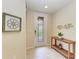 Inviting foyer with a decorative mirror and wood table at 6708 Grand Estuary Trl # 104, Bradenton, FL 34212