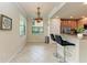 Bright kitchen nook with bar seating and stainless steel appliances at 6708 Grand Estuary Trl # 104, Bradenton, FL 34212