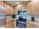 Close-up of kitchen appliances and countertops with tiled backsplash at 6708 Grand Estuary Trl # 104, Bradenton, FL 34212