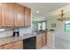 Kitchen counter with granite countertops, coffee machine, and view to the living area at 6708 Grand Estuary Trl # 104, Bradenton, FL 34212