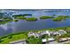 Aerial view showcasing waterfront community and lush landscaping at 1520 Pelican Point Dr # 251, Sarasota, FL 34231