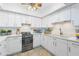 Modern white kitchen with stainless steel appliances at 1520 Pelican Point Dr # 251, Sarasota, FL 34231