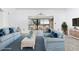 Virtually staged living room with water view at 1520 Pelican Point Dr # 251, Sarasota, FL 34231