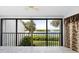 Living room featuring serene water views and access to balcony at 1520 Pelican Point Dr # 251, Sarasota, FL 34231