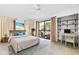 Main bedroom with private balcony and built-in shelves at 1520 Pelican Point Dr # 251, Sarasota, FL 34231