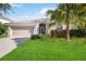 Single-story house with a two-car garage and lush lawn at 9009 Kingsbury Pl, Bradenton, FL 34212