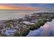 Aerial view of waterfront property at sunset at 7665 Sanderling Rd, Sarasota, FL 34242