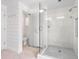 Modern bathroom with walk-in shower, toilet, and white shiplap walls at 7665 Sanderling Rd, Sarasota, FL 34242