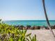 Scenic beach view with calm water and white sand at 7665 Sanderling Rd, Sarasota, FL 34242