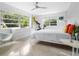 Bright bedroom with a queen bed, exercise bike and large windows at 7665 Sanderling Rd, Sarasota, FL 34242