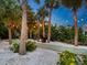 Outdoor bocce ball court with fire pit and string lights at 7665 Sanderling Rd, Sarasota, FL 34242