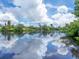 Calm canal reflecting clouds and houses at 7665 Sanderling Rd, Sarasota, FL 34242