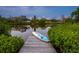 Wooden dock with paddleboard by the canal at 7665 Sanderling Rd, Sarasota, FL 34242