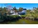 Waterfront home with solar panels and lush landscaping at 7665 Sanderling Rd, Sarasota, FL 34242