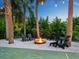Fire pit with seating area and string lights at 7665 Sanderling Rd, Sarasota, FL 34242