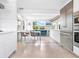 Modern white kitchen with stainless steel appliances and breakfast area at 7665 Sanderling Rd, Sarasota, FL 34242