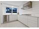 Modern kitchen with stainless steel appliances and white shaker cabinets at 7665 Sanderling Rd, Sarasota, FL 34242