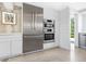 Stainless steel appliances and white shaker cabinets in this modern kitchen at 7665 Sanderling Rd, Sarasota, FL 34242