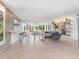 Bright living room features open floor plan, concrete floors, and built-in shelving at 7665 Sanderling Rd, Sarasota, FL 34242