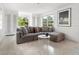 Living room with sectional sofa and large windows at 7665 Sanderling Rd, Sarasota, FL 34242