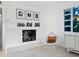 Living room with fireplace and mid century modern furniture at 7665 Sanderling Rd, Sarasota, FL 34242