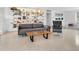 Living area features mid-century modern furniture, built-in shelving, and terrazzo floors at 7665 Sanderling Rd, Sarasota, FL 34242