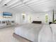 Main bedroom with large windows, TV, and plenty of natural light at 7665 Sanderling Rd, Sarasota, FL 34242