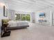 Main bedroom with large windows, TV, and plenty of natural light at 7665 Sanderling Rd, Sarasota, FL 34242