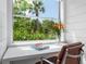 Small home office with window view and white desk at 7665 Sanderling Rd, Sarasota, FL 34242