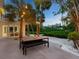 Outdoor patio with modern dining set and canal view at 7665 Sanderling Rd, Sarasota, FL 34242