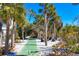 Landscaped outdoor shuffleboard court with palm trees at 7665 Sanderling Rd, Sarasota, FL 34242