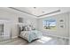 Bright bedroom with large window, light-grey walls, and a plush bed at 7889 Mainsail Ln, Sarasota, FL 34240