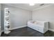 Spacious bedroom with dark hardwood floors and a white daybed at 7889 Mainsail Ln, Sarasota, FL 34240