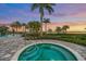 Community hot tub with palm trees and sunset views at 7889 Mainsail Ln, Sarasota, FL 34240