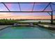 Relaxing pool and spa with covered lanai, offering stunning sunset views at 7889 Mainsail Ln, Sarasota, FL 34240