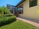 Landscaped backyard with brick patio and wooden steps at 12313 Baypointe Ter, Cortez, FL 34215