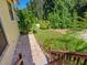 Landscaped backyard with brick patio and steps at 12313 Baypointe Ter, Cortez, FL 34215