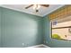 Light green bedroom with carpet and window at 12313 Baypointe Ter, Cortez, FL 34215