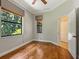 Spacious bedroom with wood floors and access to bathroom at 12313 Baypointe Ter, Cortez, FL 34215