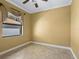 Simple bedroom with tile floors and window at 12313 Baypointe Ter, Cortez, FL 34215