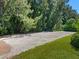 Large gravel driveway area next to lush greenery at 12313 Baypointe Ter, Cortez, FL 34215