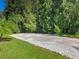 Large gravel driveway area next to lush greenery at 12313 Baypointe Ter, Cortez, FL 34215