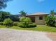 Single story house exterior with tile roof and landscaping at 12313 Baypointe Ter, Cortez, FL 34215