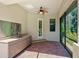 Outdoor kitchen with granite countertops, stainless steel sink, and custom cabinetry at 12313 Baypointe Ter, Cortez, FL 34215